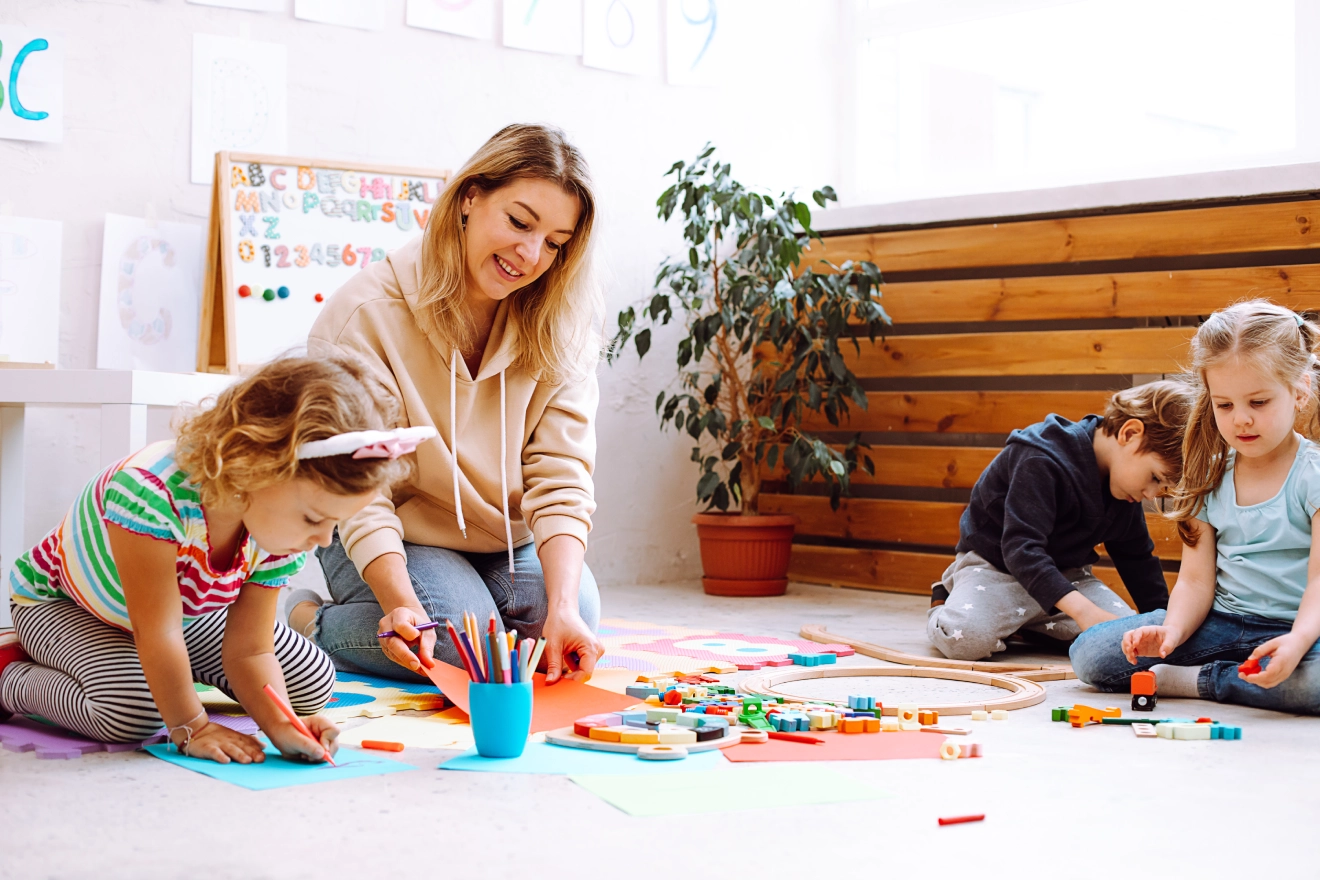GettyImages-1421270936 Teacher and children playing with colorful toys.
