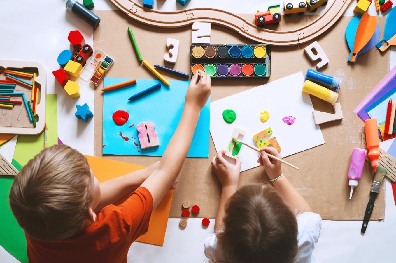 GettyImages-1835189542 Children painting with colorful art supplies.