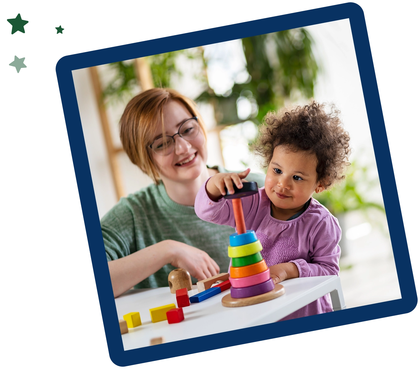 A woman and child playing with toys on the table.